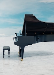 a black piano sitting on top of a white floor