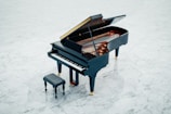 The same piano lid after restoration, gleaming with a smooth high-gloss finish.