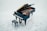 A grand piano with its lid open, showcasing the strings and internal components, placed on a light grey marble floor. There is a matching piano bench positioned in front of the piano.