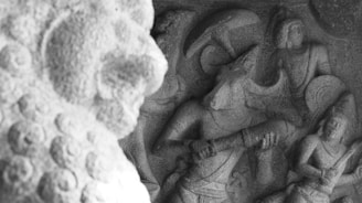 A detailed stone carving depicting a mythological scene, featuring figures with intricate detailing, including one with a bull-like head holding a weapon. Other figures appear engaged with each other, with dynamic poses suggesting movement. The setting is an ancient or historical style, showing high craftsmanship.