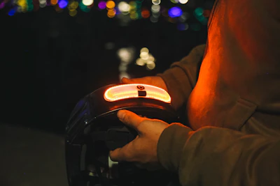 a person driving a car at night with a city in the background