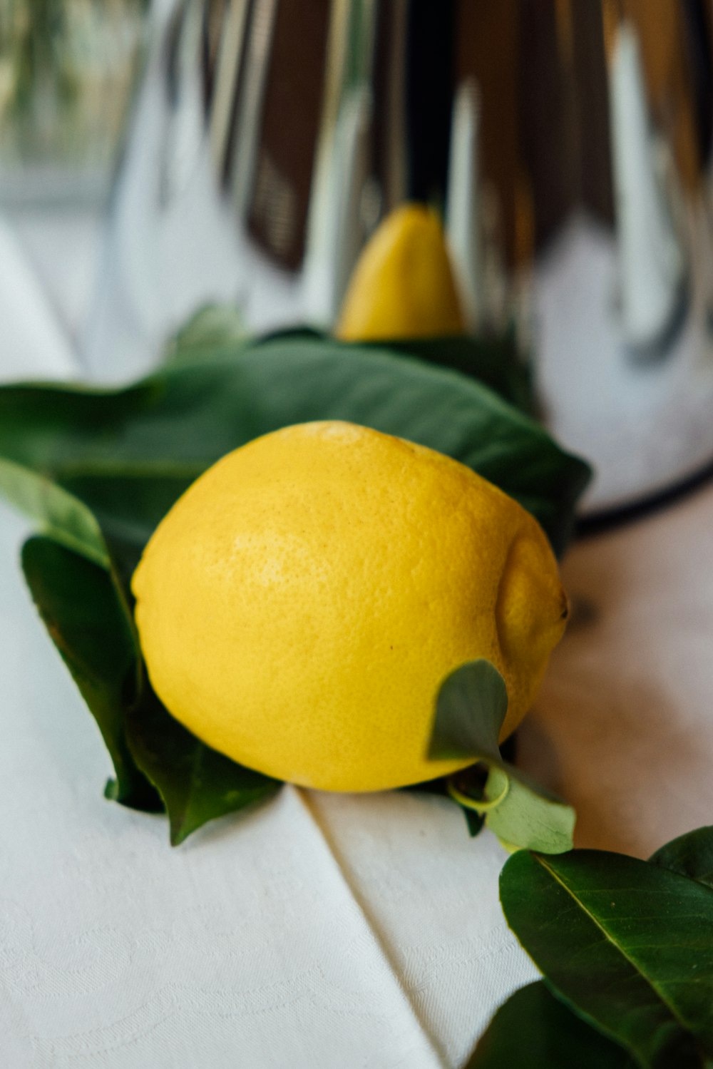 a lemon sitting on top of a white cloth