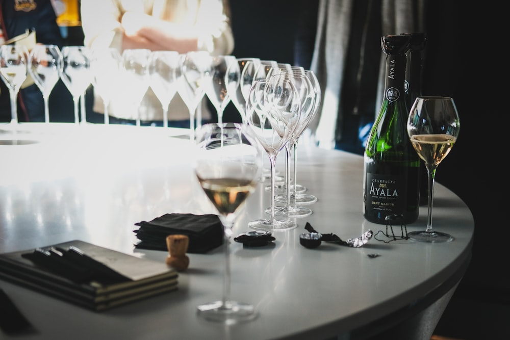 a table topped with wine glasses and a bottle of wine