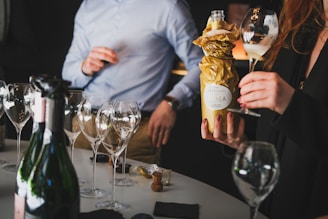 a group of people standing around a table with wine glasses