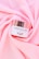 A jar of Supreme Facial Cream with a metallic lid is placed elegantly on soft, pink fabric. The cream is labeled as moisturizing, whitening, and revitalizing, with a confident tagline beneath the brand name.