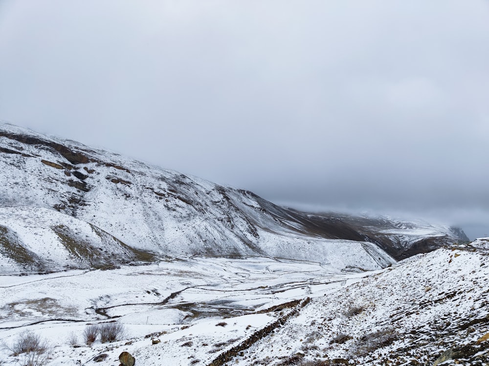 a person standing on a snow covered hill