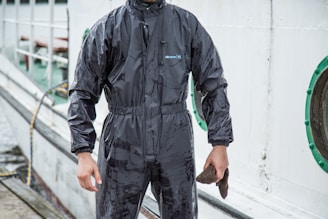 a man in a wet suit holding a fish