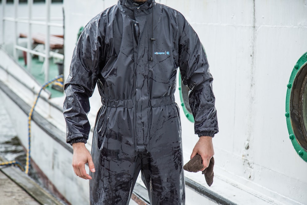 a man in a wet suit holding a fish