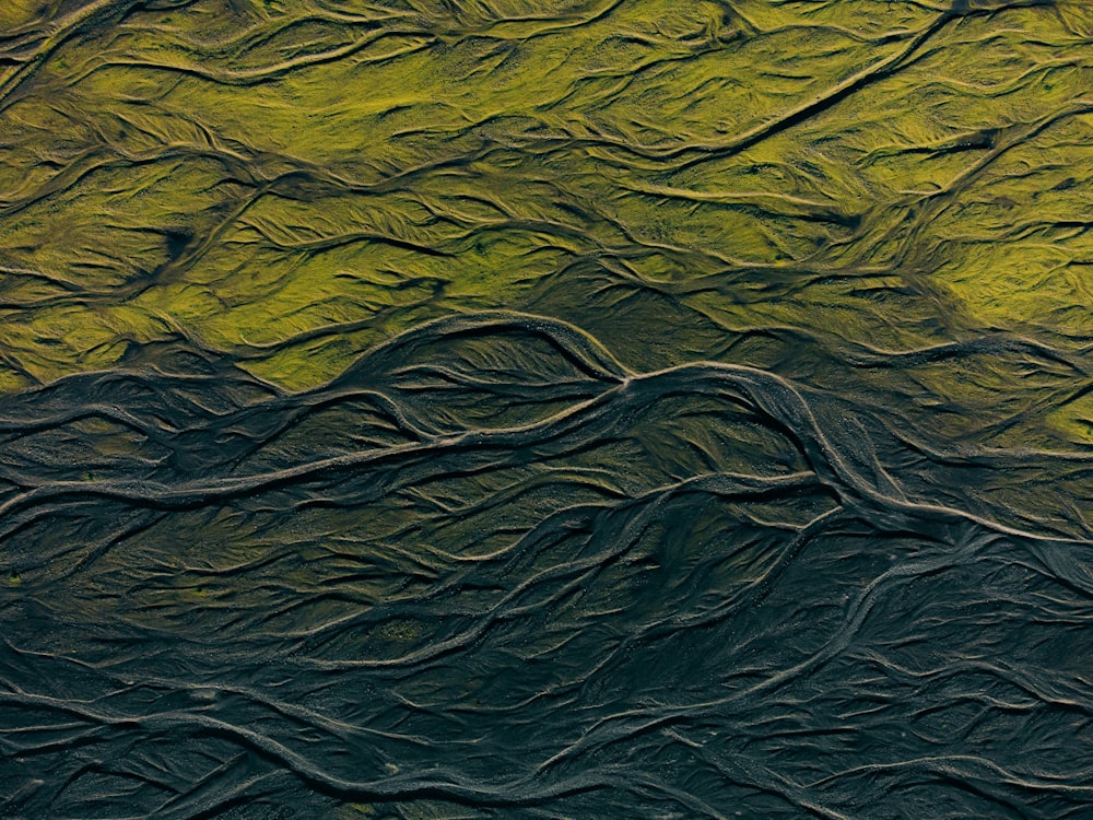 an abstract painting of a green mountain