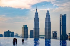 a couple of people that are standing in a pool