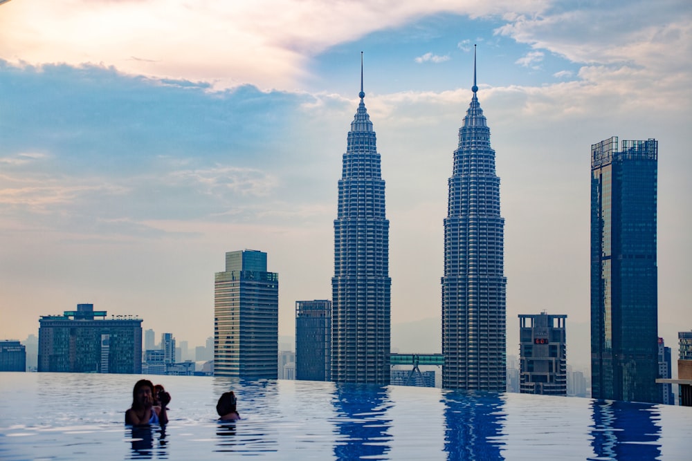 a couple of people that are standing in a pool