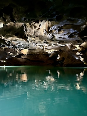 A serene underwater cave illuminated by a diver’s flashlight revealing stunning rock textures.