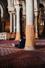 a man sitting on the floor of a large building