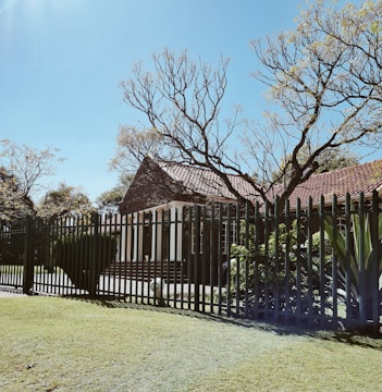 Photo of a vacant residential house in Winchester fully secured with fencing and alarms.