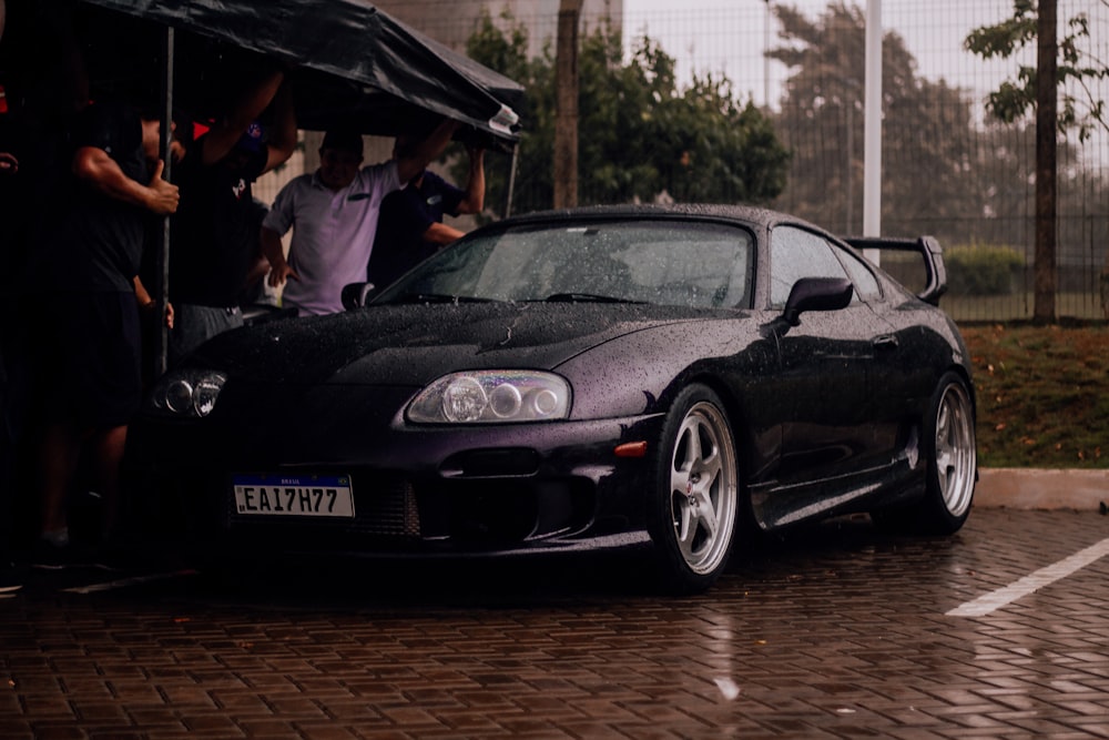 a black sports car parked in a parking lot