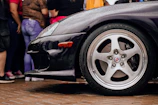 Shiny black tires with a deep, wet tire shine finish on a sleek vehicle.