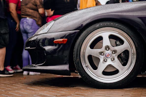 Shiny black tires with a deep, wet tire shine finish on a sleek vehicle.