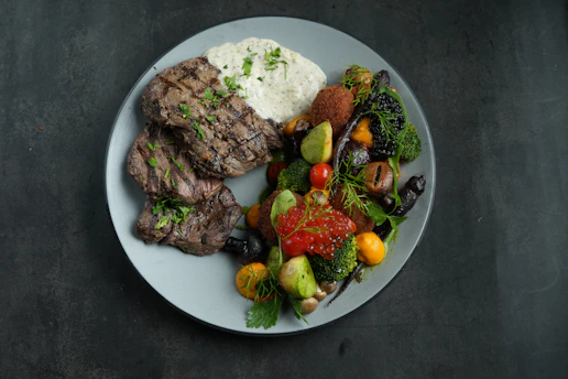 a white plate topped with meat and vegetables
