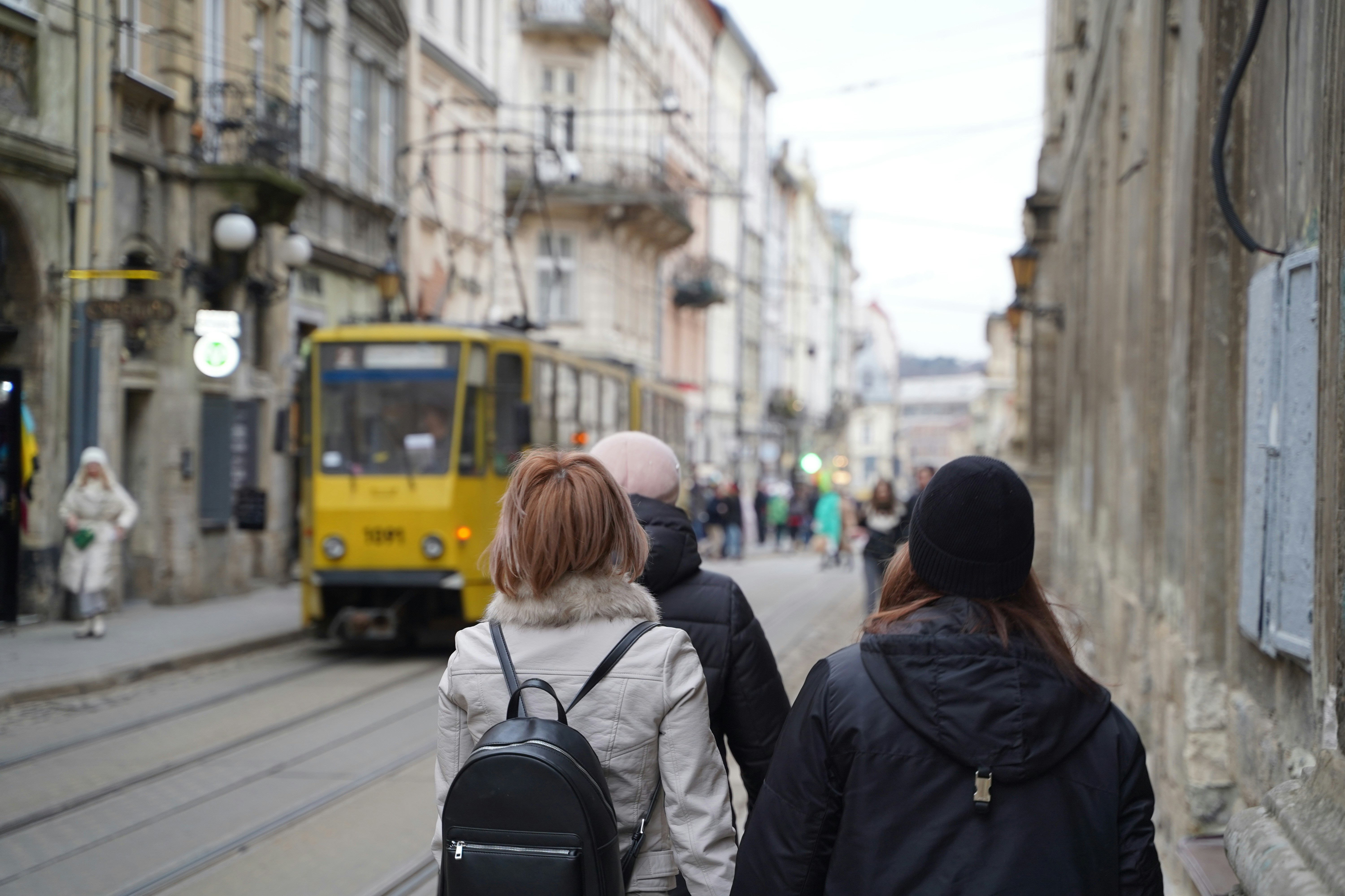 a couple of people that are walking down a street