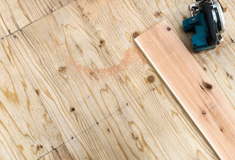 a piece of wood with a drill and a piece of wood on top of it