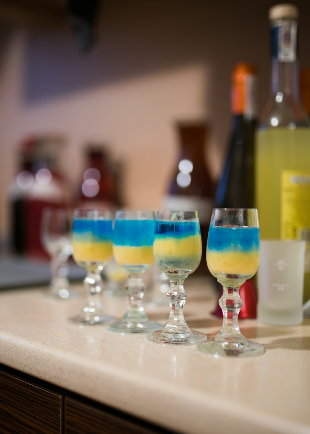 a row of wine glasses sitting on top of a counter