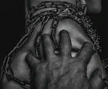 Close-up of hands breaking chains representing breaking mental health stigma