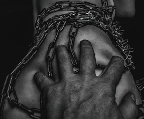 Close-up of hands breaking chains representing breaking mental health stigma