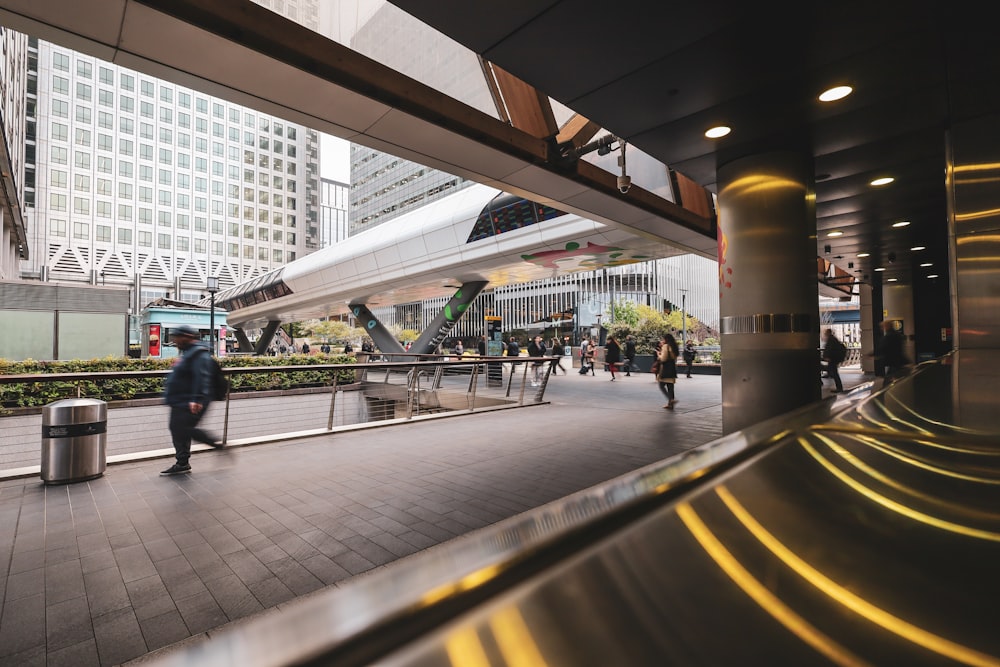 a group of people walking around a train station