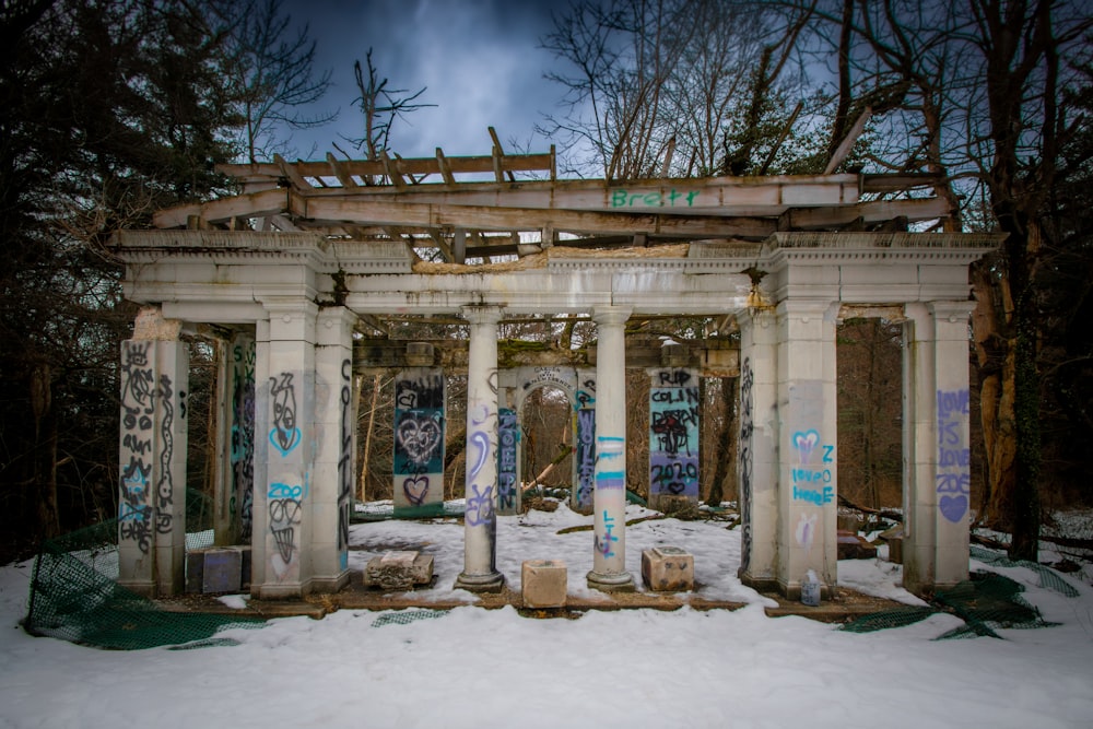 an old building with graffiti on it in the snow