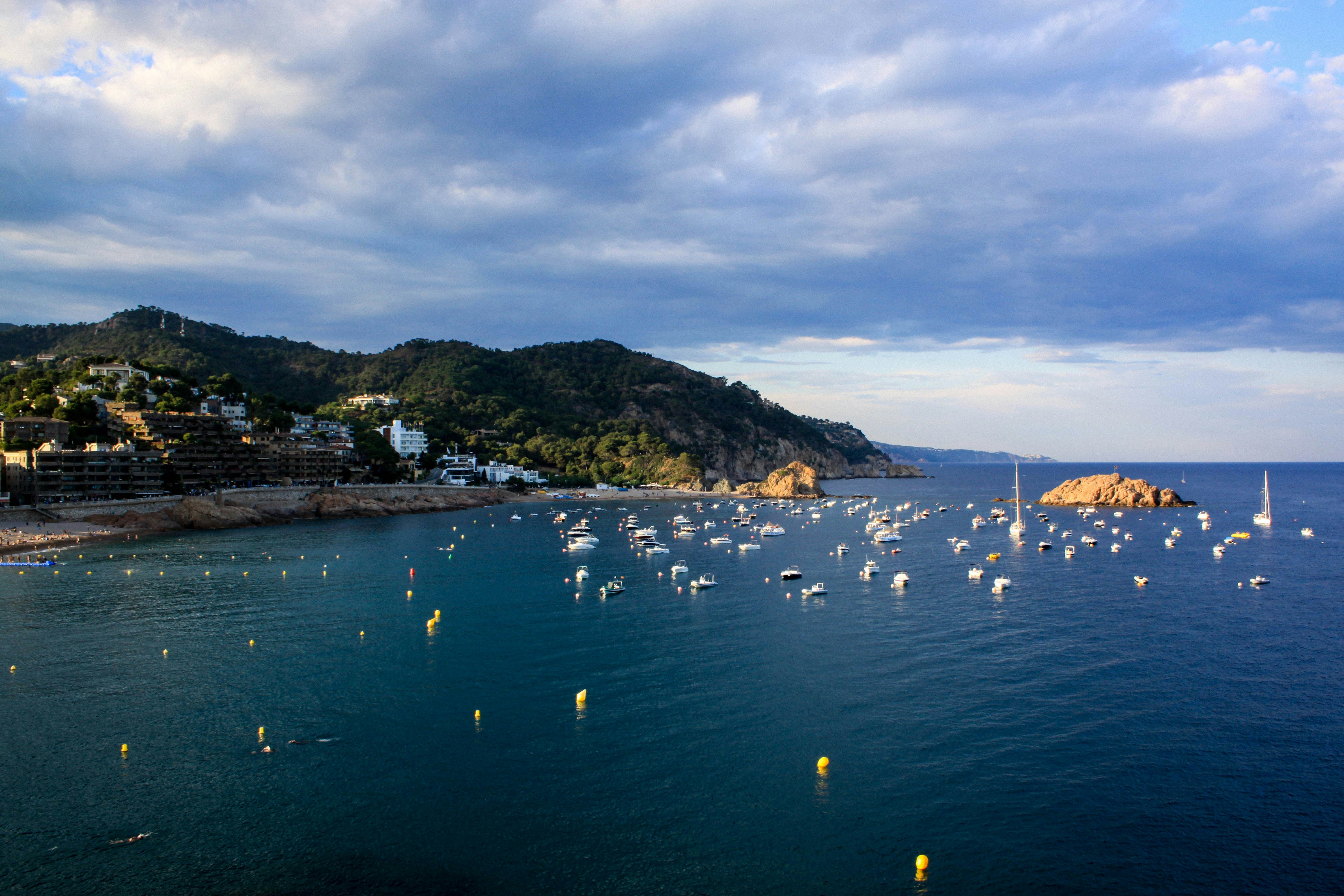 A large body of water filled with lots of boats photo Free Tossa de
