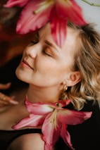 Smiling woman enjoying a morning routine with fresh flowers nearby