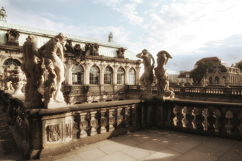 a building with statues on the balcony of it