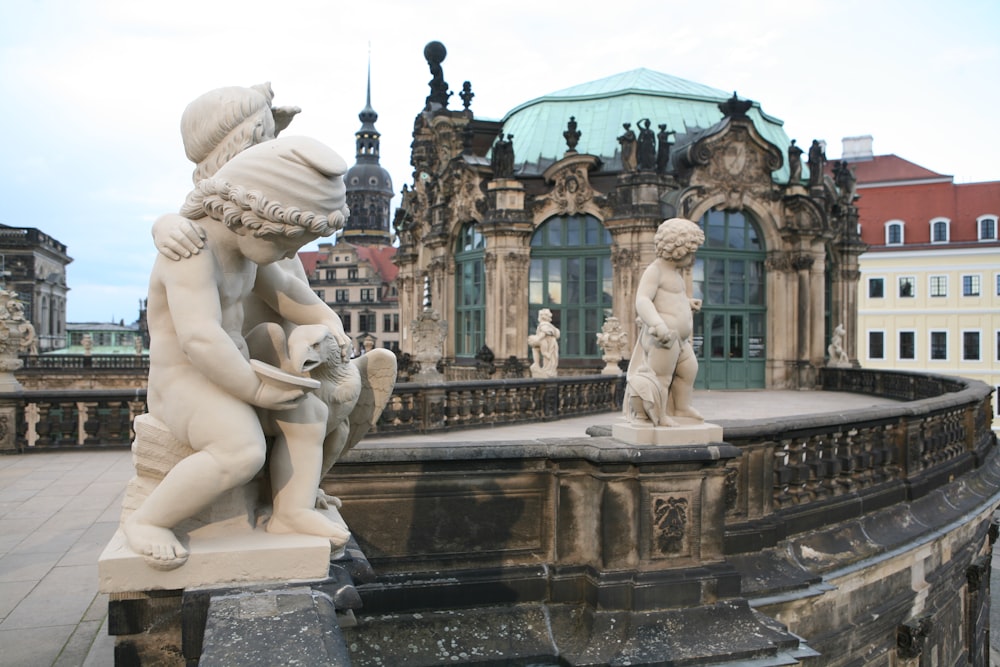 a statue of a boy and a girl on a fountain