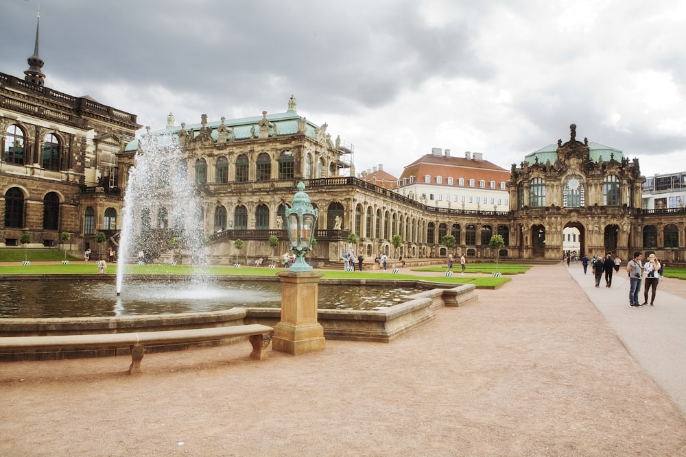 a large building with a fountain in front of it