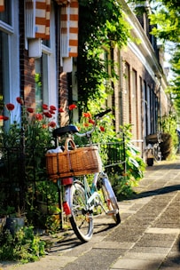 A stylish crossbody bag hanging from a vintage bicycle on a charming English street.