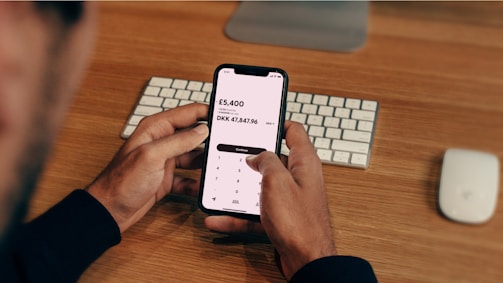 A friendly consultant at a desk in a London office, ready to assist with FX payment solutions.