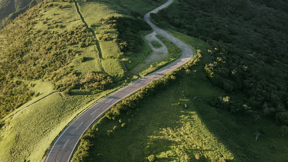 an aerial view of a winding road in the mountains