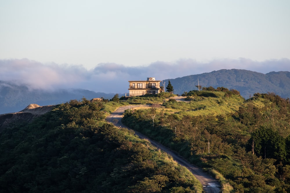 a house sitting on top of a lush green hillside