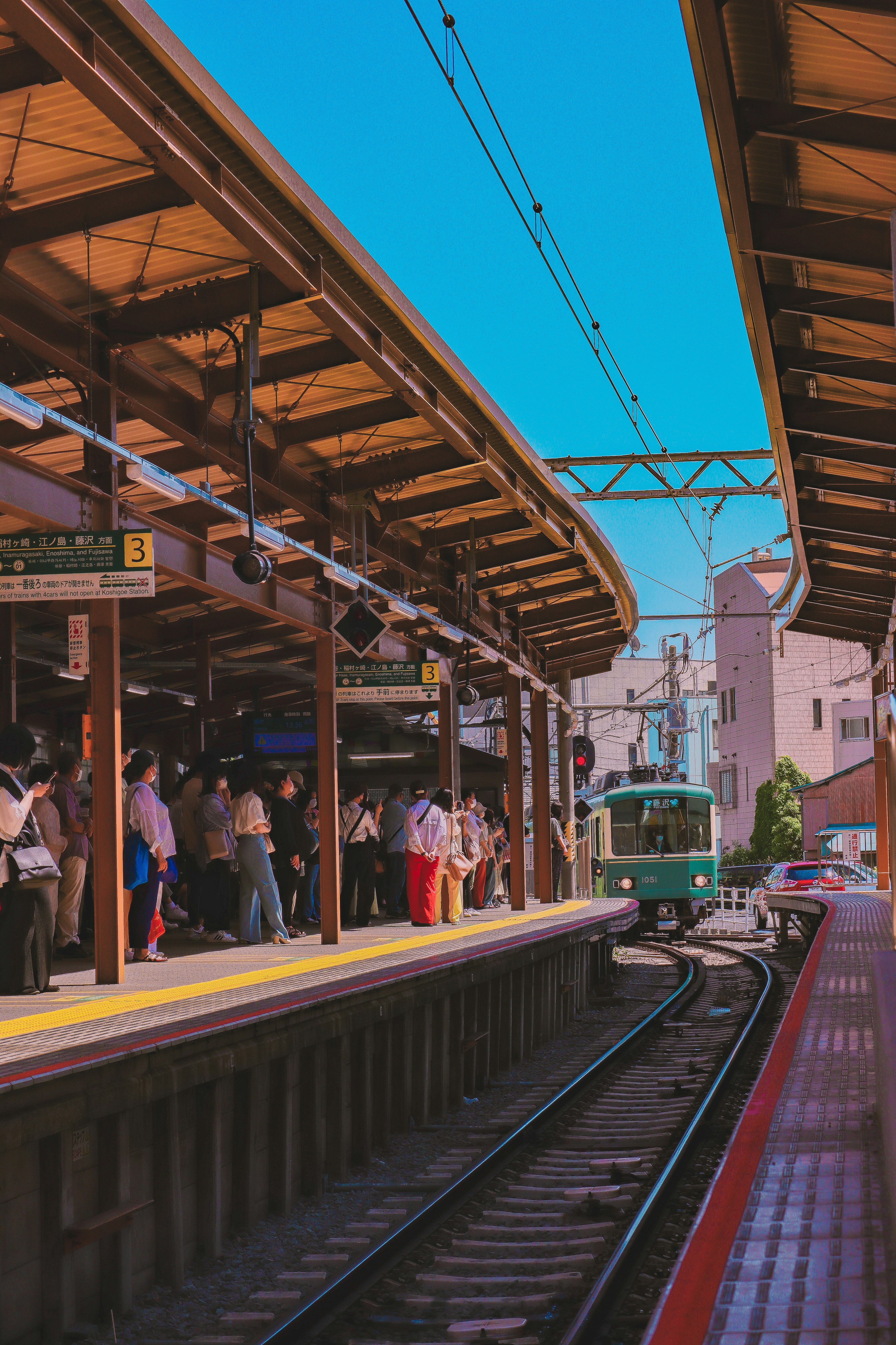 a group of people waiting at a train station