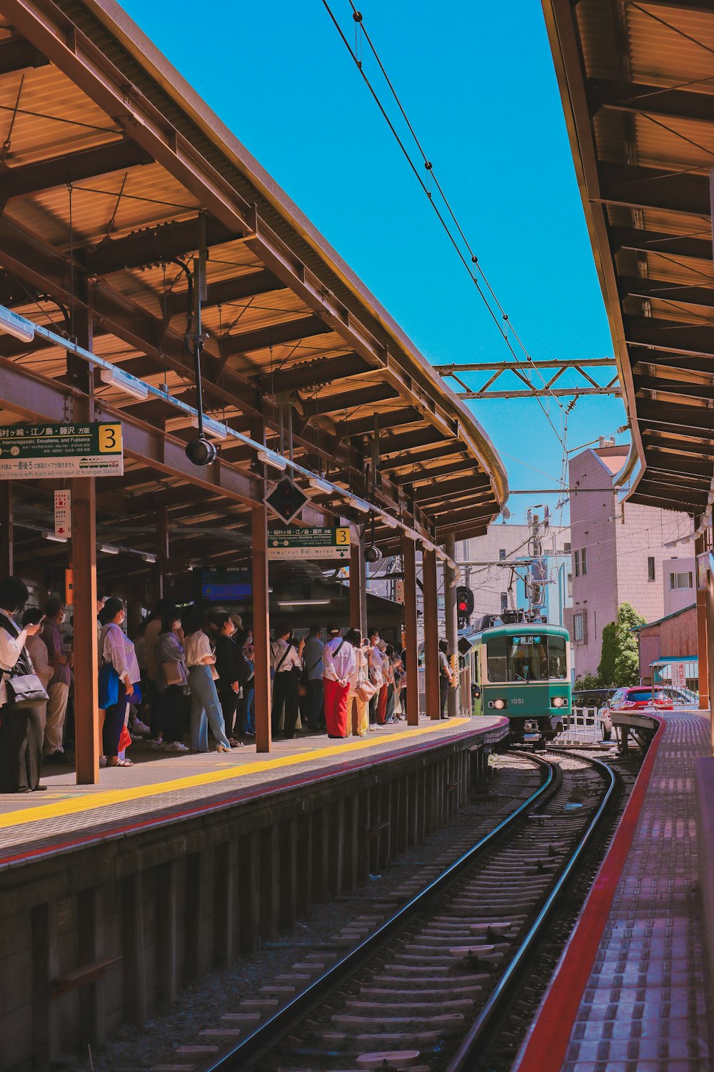 a group of people waiting at a train station