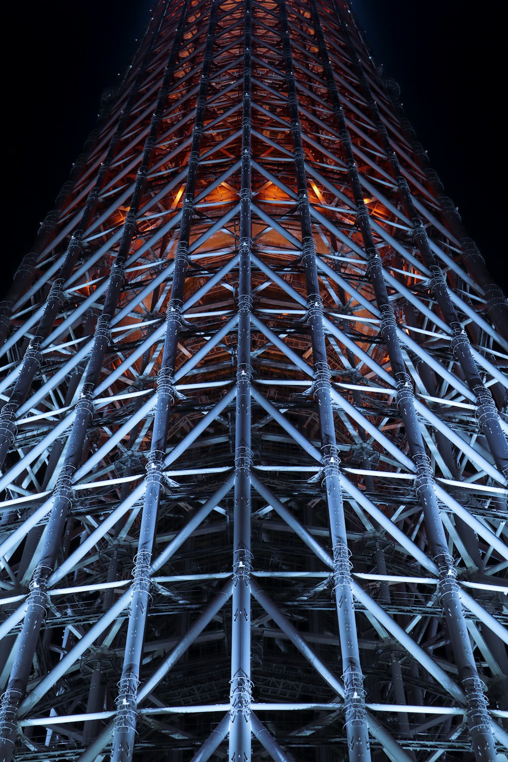 the top of a tall building lit up at night