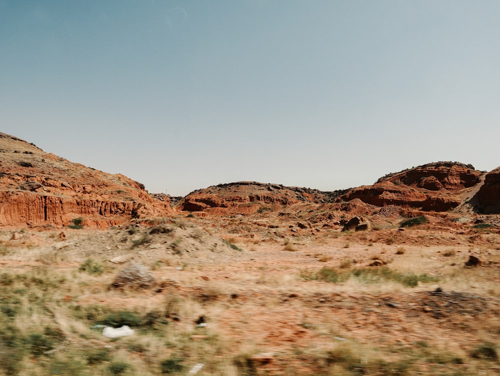 a desert landscape with a mountain in the background