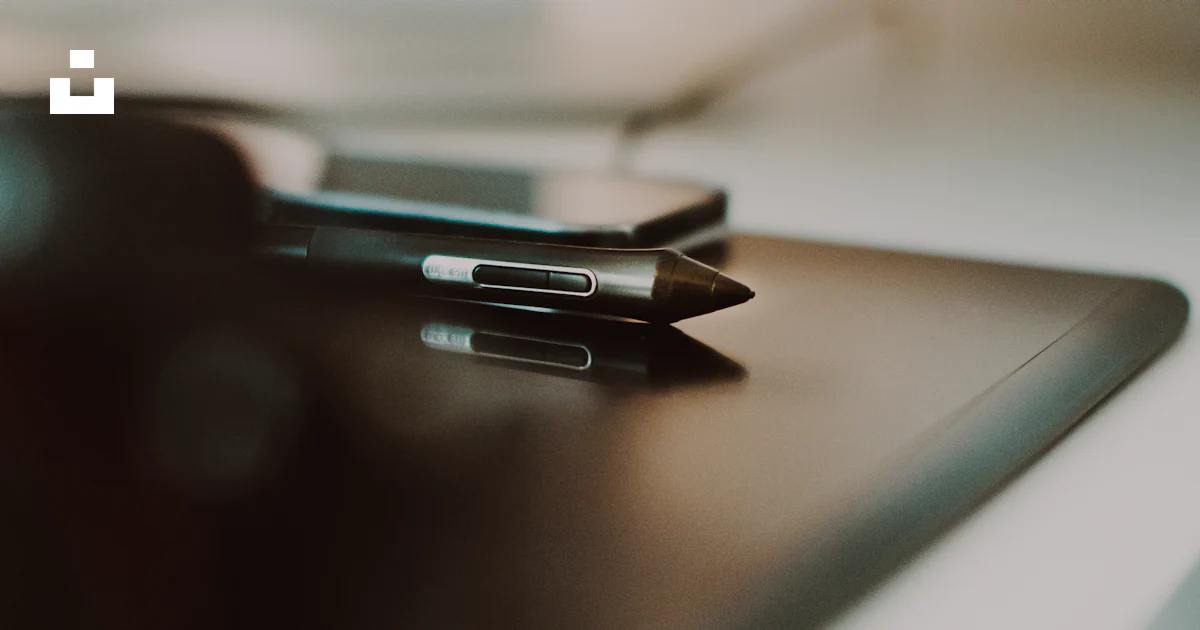A close up of two electronic devices on a table photo – Free Computer ...