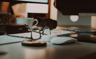 A cluttered workspace with tech gadgets, cables, and a cup of coffee.