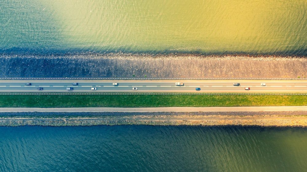 an aerial view of a highway near a body of water