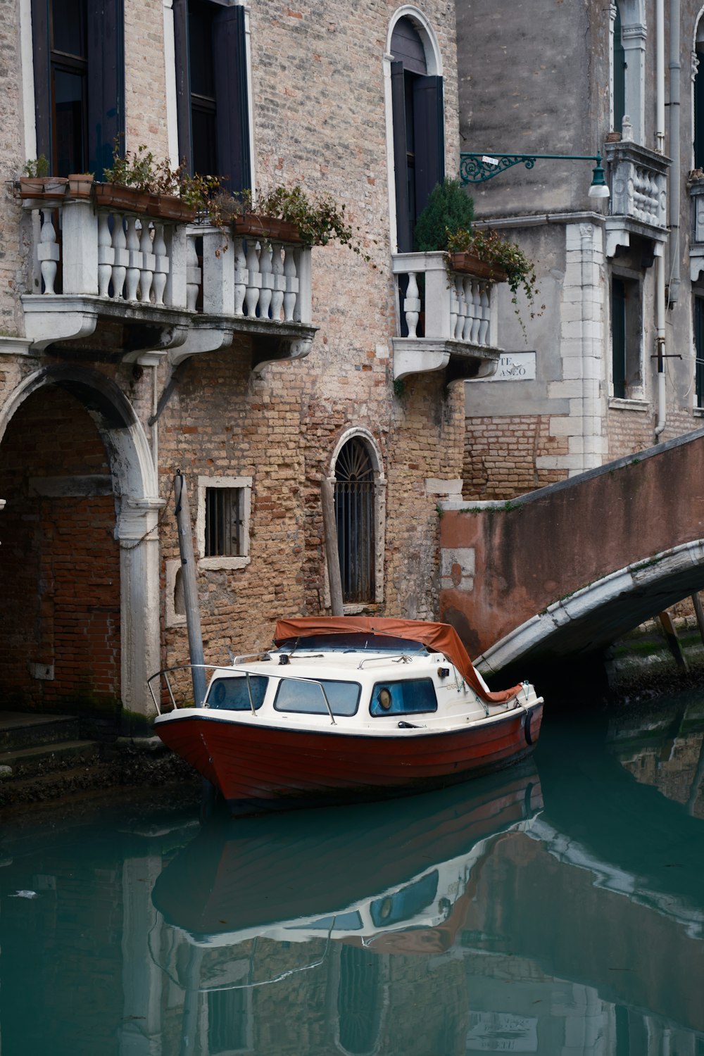 a small boat is docked in a canal