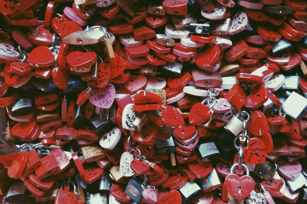 a pile of red heart shaped padlocks