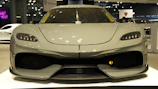 A sleek Japanese sports car ready for export, gleaming under bright showroom lights.