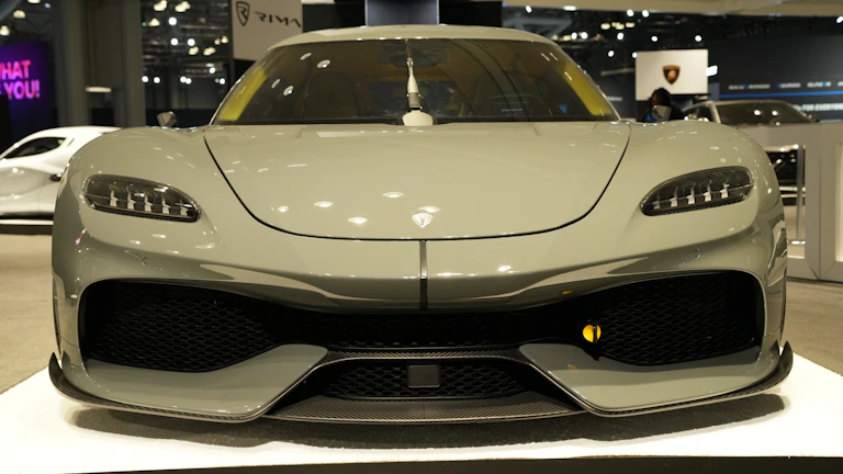 A sleek Japanese sports car ready for export, gleaming under bright showroom lights.