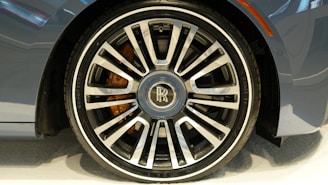 A close-up of a high-performance car wheel with a glossy finish on display.